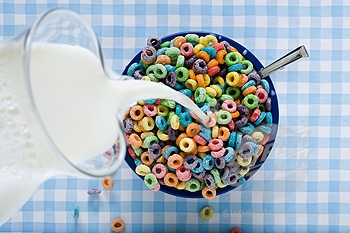 pouring milk into cereal