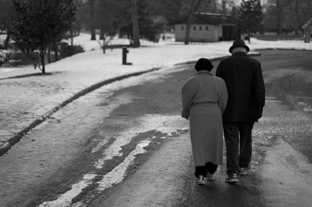 elderly couple holding hands